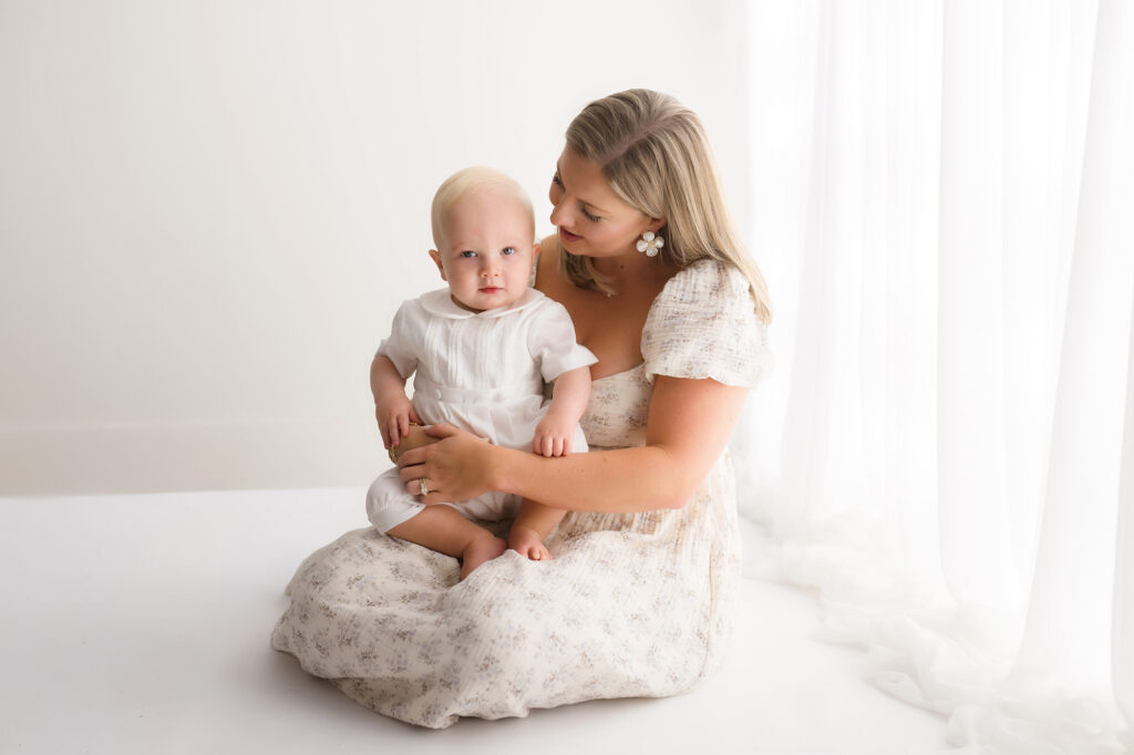 Mother embraces her baby at the top of his Classic Heirloom Portraits in Charleston South Carolina.