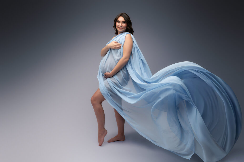 Pregnant woman poses for Studio Maternity Portraits in Charleston during her Babymoon after discovering The Ultimate Charleston Babymoon Planning Guide.