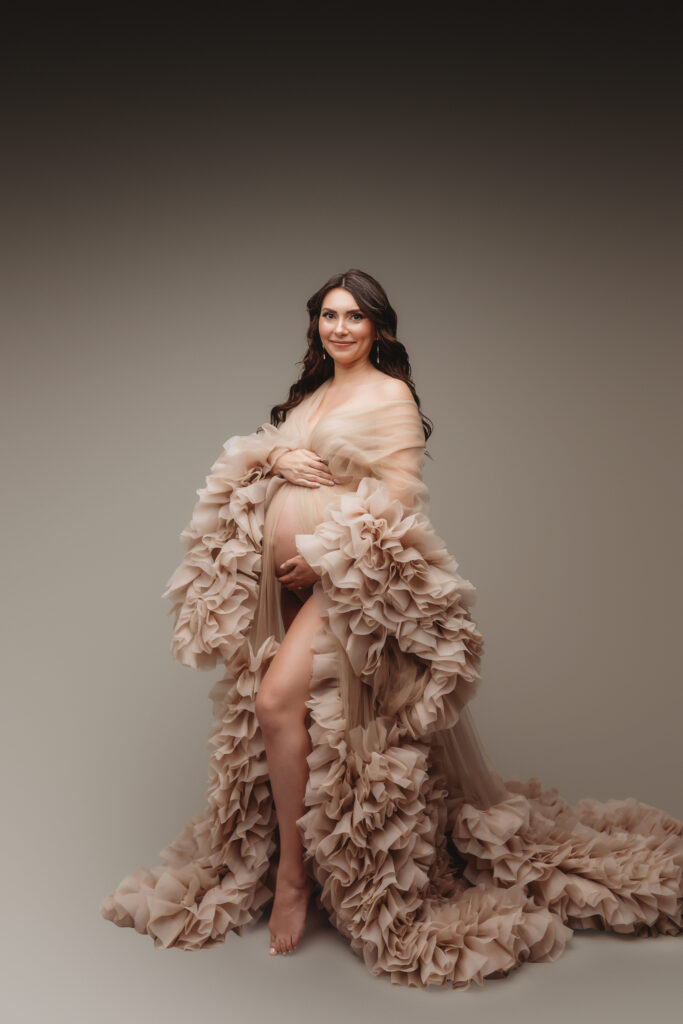Pregnant woman poses for Studio Maternity Portraits in Charleston during her Babymoon after discovering The Ultimate Charleston Babymoon Planning Guide.