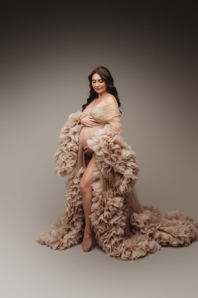 Pregnant woman poses for Studio Maternity Portraits in Charleston during her Babymoon after discovering The Ultimate Charleston Babymoon Planning Guide.