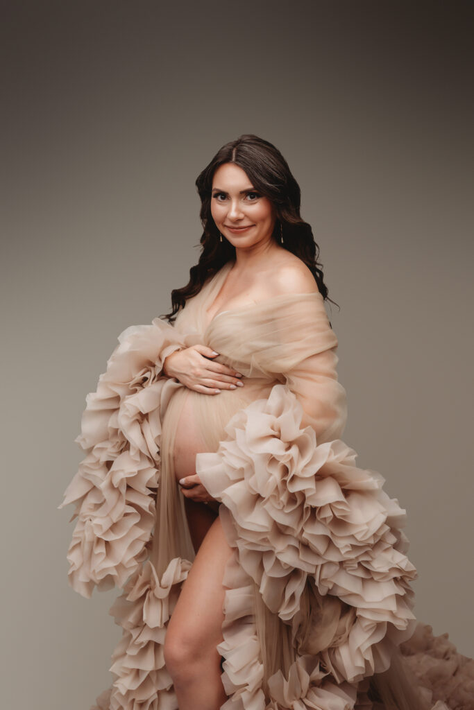 Pregnant woman poses for Studio Maternity Portraits in Charleston during her Babymoon after discovering The Ultimate Charleston Babymoon Planning Guide.