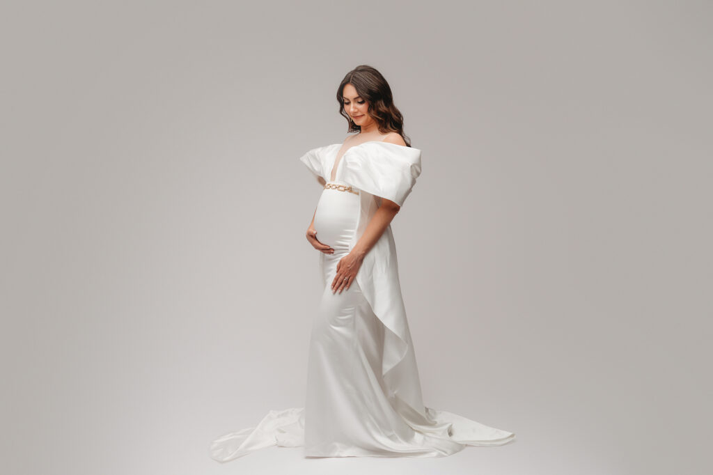 Pregnant woman poses for Studio Maternity Portraits in Charleston during her Babymoon after discovering The Ultimate Charleston Babymoon Planning Guide.
