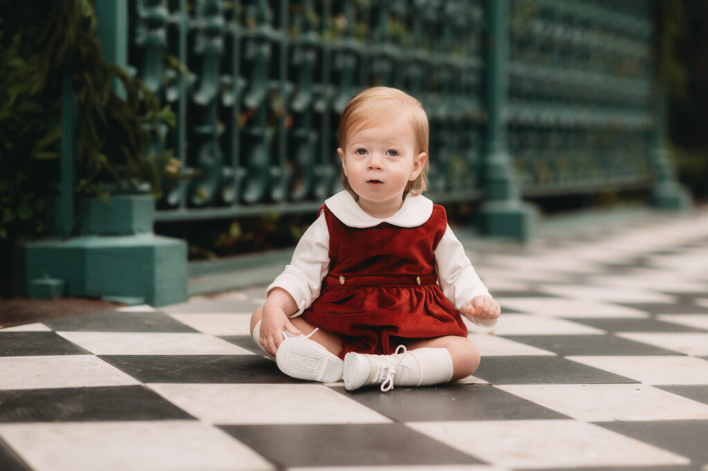 Baby smiles at the camera during Downtown Charleston Holiday Mini Sessions. 