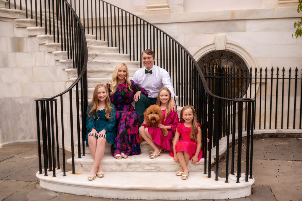 Family poses together at City Hall during Downtown Charleston Holiday Mini Sessions.