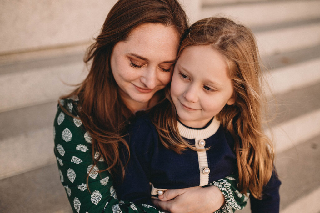 Mother embraces her daughter during Downtown Charleston Holiday Mini Sessions