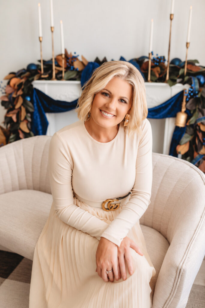 Mother smiles at the camera during Holiday Mini Sessions in Charleston at Holy City Babies Portrait Studio in the Avondale neighborhood of Charleston.